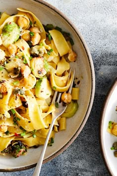 two plates of pasta with broccoli and shrimp