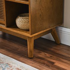 a wooden cabinet with a basket on top