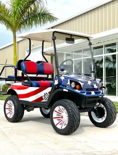 an american flag golf cart parked in front of a building with palm trees behind it