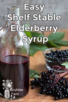 elderberry syrup in a glass bottle next to berries