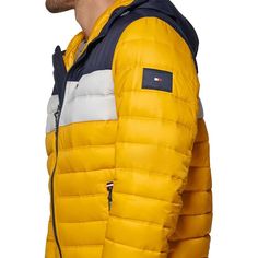 This men's quilted color blocked puffer jacket from Tommy Hilfiger is certain to elevate any Instagram adventure. Featuring a modern wind-resistant design with cozy polyester fill, full front zip and adjustable hood, you'll look as good hitting the trails or running errands. The lightweight construction and two zip pockets keep essentials secure while diagonal color blocking adds instant street style. Complete with Tommy logos for recognizable design, stay stylish and comfortable for any daily e Color Block Nylon Outerwear For Outdoor Activities, Color Block Nylon Outerwear For Outdoor, Nylon Color Block Outerwear For Outdoor Activities, Yellow Outdoor Hooded Jacket With Adjustable Hood, Yellow Hooded Jacket With Adjustable Hood For Outdoor, Hooded Color Block Outerwear For Outdoor Activities, Yellow Hooded Jacket With Drawstring For Outdoor, Yellow Hooded Puffer Jacket For Outdoor, Urban Color Block Outerwear For Outdoor