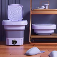 a purple and white cooler sitting on top of a wooden floor next to a computer mouse