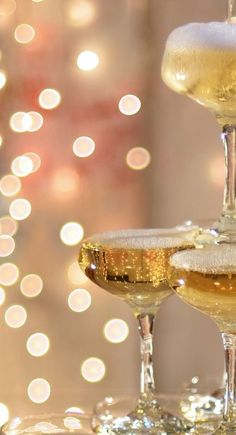 three glasses of champagne sitting on top of a table