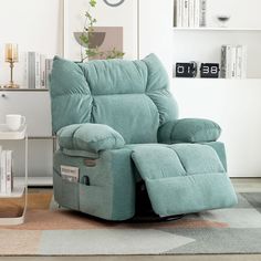 a blue recliner chair sitting on top of a rug