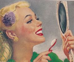 a woman is brushing her teeth with a toothbrush in front of a mirror that has a flower on it