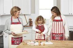 Find the merriest gift for Grandma, our Grandma Chef Apron. The washed canvas apron features a Christmas plaid pattern on the trim. The apron has a front pocket that features the words "Grandma Chef". The apron has adjustable neckline hardware making it adjust to fit perfectly. | Mud Pie Grandma Chef Apron in Tan | Cotton Plaid Apron, Christmas Pie, Canvas Apron, Family Baking, Lemonade Party, Baking Apron, Christmas Plaid, Cotton Apron, Chef Apron