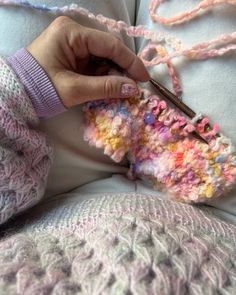 a person is knitting something with crochet