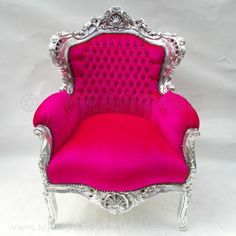 a pink chair with silver trimmings on the back and arms, sitting against a white background