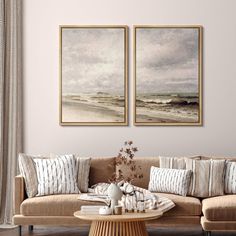 two paintings hang on the wall above a couch in a living room with beige furniture