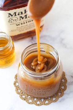 caramel sauce being poured into a jar