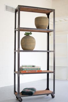 a book shelf with two vases on top of it and books in the bottom