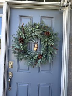 a blue door with a wreath and bells on it