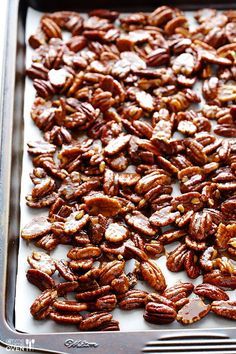 a tray filled with pecans on top of a table