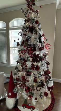 a white christmas tree with red and black decorations