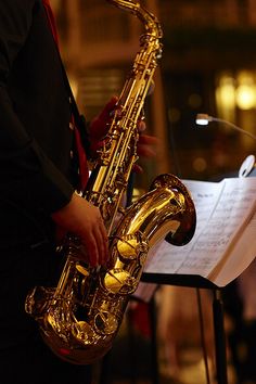 a saxophone player is playing music on the street