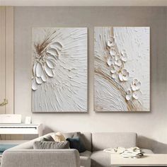 two paintings on the wall in a living room