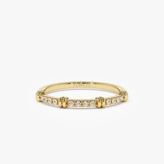 a yellow gold ring with small diamonds