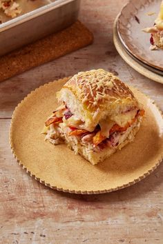 a sandwich on a plate next to a baking pan