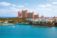 an aerial view of the resort from across the water, with boats in the foreground