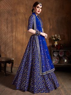 Featuring a stunning blue-colored bridal raw silk wedding lehenga, this ensemble is designed to make you the center of attention on any special occasion. Made from high-quality raw silk material, this lehenga is crafted with intricate zari work, sequin work, and heavy embroidery all over, adding a touch of elegance and grandeur.
Accompanied by a matching color choli, also made from a similar raw silk material, this ensemble is complete with the same zari work, sequin work, and heavy embroidery. Royal Blue Lehenga, Engagement Lehenga, Indian Bridesmaids, Silk Lehenga Choli, Raw Silk Lehenga, Wedding Dress Outfit, Saree Lehenga, Bollywood Lehenga, Blue Lehenga