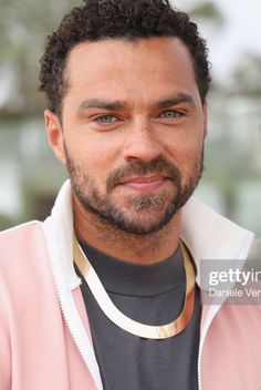 a close up of a person wearing a pink jacket