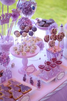 a table topped with lots of desserts and candies