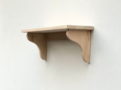 a wooden shelf mounted to the side of a wall