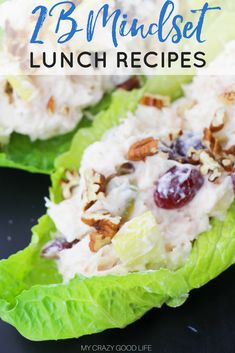 two lettuce cups filled with chicken salad and cranberry sauce on top