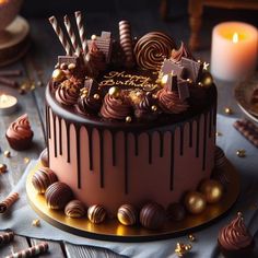 there is a chocolate cake on the table with many candies and candles around it