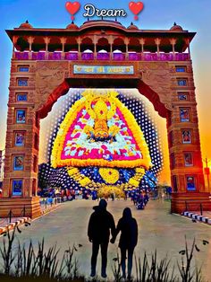 two people standing in front of an arch with the words dream written on it,