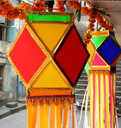 three brightly colored vases sitting next to each other in front of a building with stairs