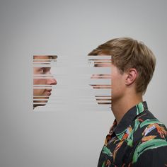 a man standing in front of a mirror with his face cut out to look at each other