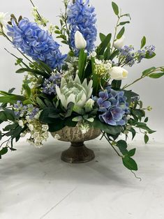 a vase filled with blue and white flowers