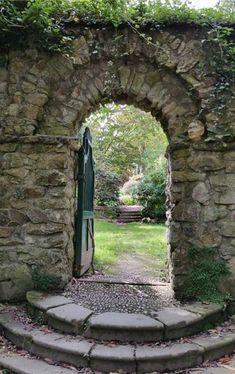 an old stone gate with steps leading into it