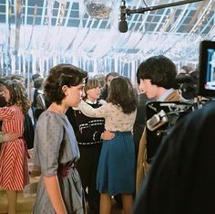 two women are talking to each other in front of a camera