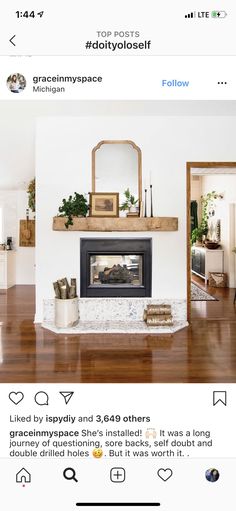 an instagramted photo of a living room with a fireplace and mirror on the wall