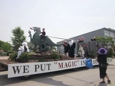 a parade float with people riding on the back of it