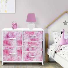 a pink and white dresser in a girls'bedroom with a giraffe painting on the wall