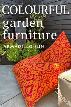 Colourful garden furniture by Armadillo Sun. Text overlaid on a photograph of a patterned orange and dark fuschia bean bag chair sat against a black fence. Bright Patio, Colourful Furniture