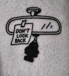 the back of a person's leg with a don't look back sticker on it