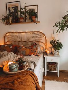 a bed room with a neatly made bed and plants