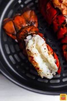 there are two lobsters on the grill and one is covered in sauce, while the other has been grilled