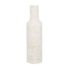 a white vase sitting on top of a table