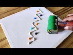 someone is painting the letters on a piece of paper