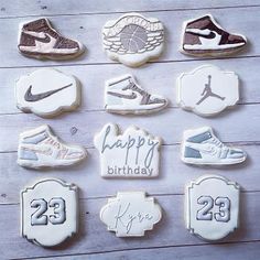 twelve decorated cookies with the number twenty and two shoes on them, all in different designs