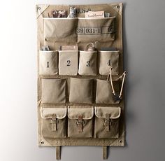 a wall hanging organizer with several pockets on it