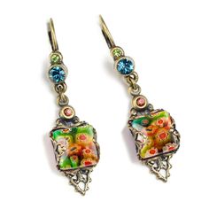 "These retro boho earrings are inspired by the geometric style of mid-century 1960s and the color fusion of today. Millefiori art glass tiles are set in open back frames, allowing light to fill the art glass. Multi color Swarovski crystal dots the frame and post. Burnished bronze finish. Size: 1.75\" long. Made in our Los Angeles studios. Sweet Romance Jewelry, USA. Millefiori means thousand flowers. Bundles of tiny glass filament rods, sliced and fired, meld their brilliant colors and floral pa Retro Dangle Earrings For Pierced Ears, Multicolor Retro Jewelry For Vintage Collection, Retro Dangle Jewelry, Retro Ear Wire Earrings, Handmade Retro Dangle Earrings, Vintage Multicolor Jewelry With Matching Earrings, Retro Multicolor Drop Earrings, Multicolor Retro Jewelry For Gift, Retro Handmade Drop Earrings