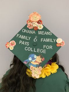 a woman wearing a green graduation cap with flowers on it's side and the words, china means family & family pays for college