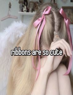 a girl with long blonde hair and pink bows on her head is looking at the camera