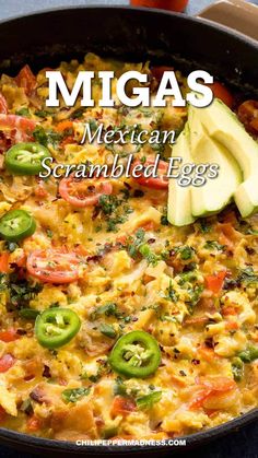 mexican scrambled eggs in a skillet with avocado and tomatoes